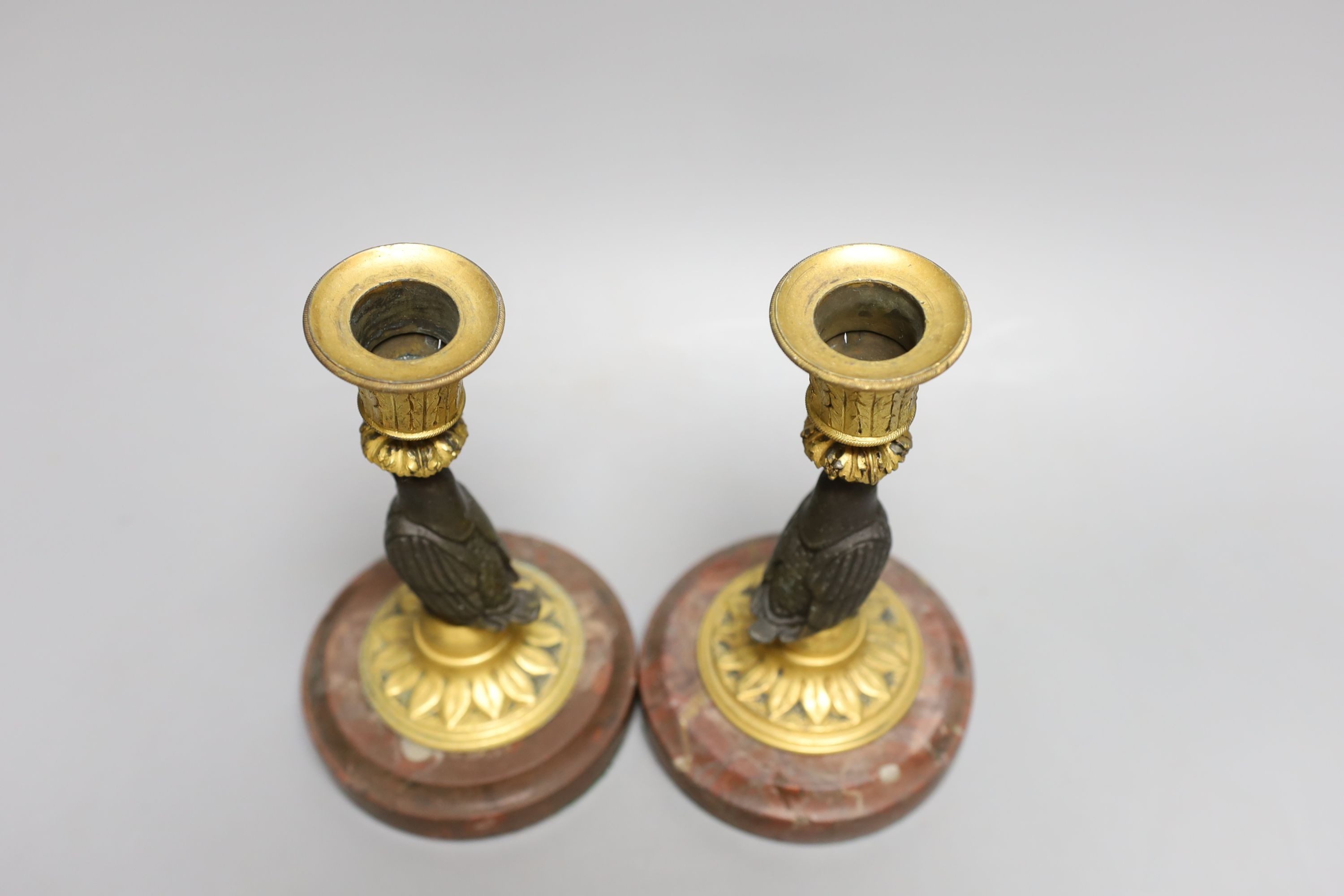 A pair of bronze and ormolu owl candlesticks - 16.5cm tall